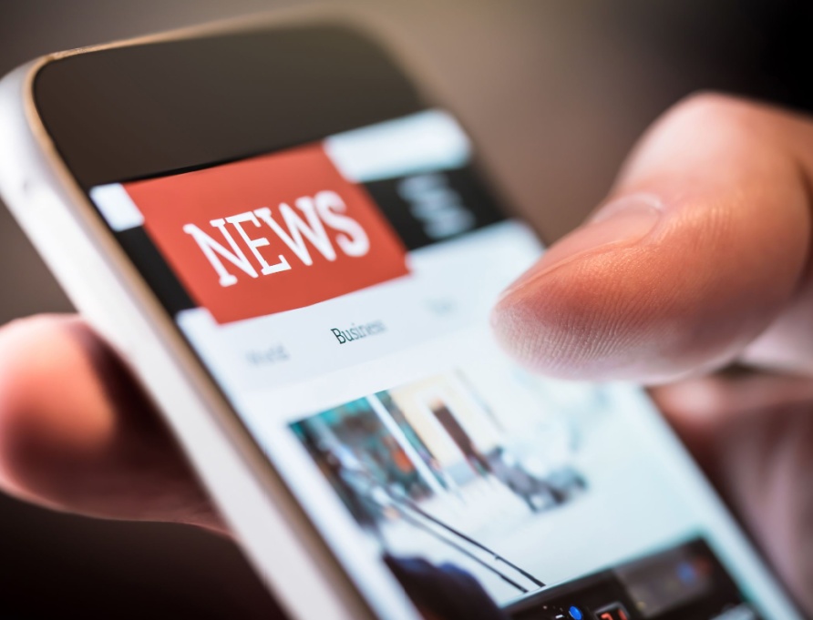 A person using a smartphone to read the news.