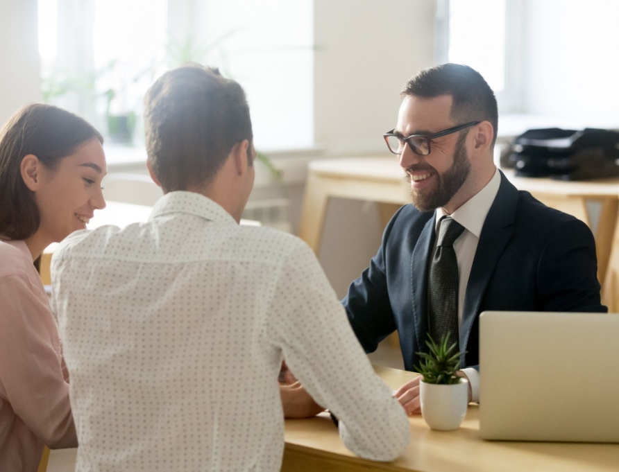 A young couple meeting with a financial planner.