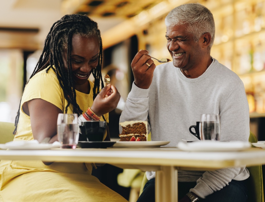 A couple laughing together at a café.