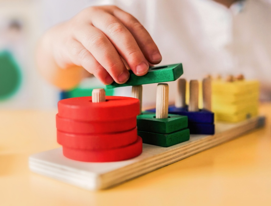A child playing with wooden shapes.
