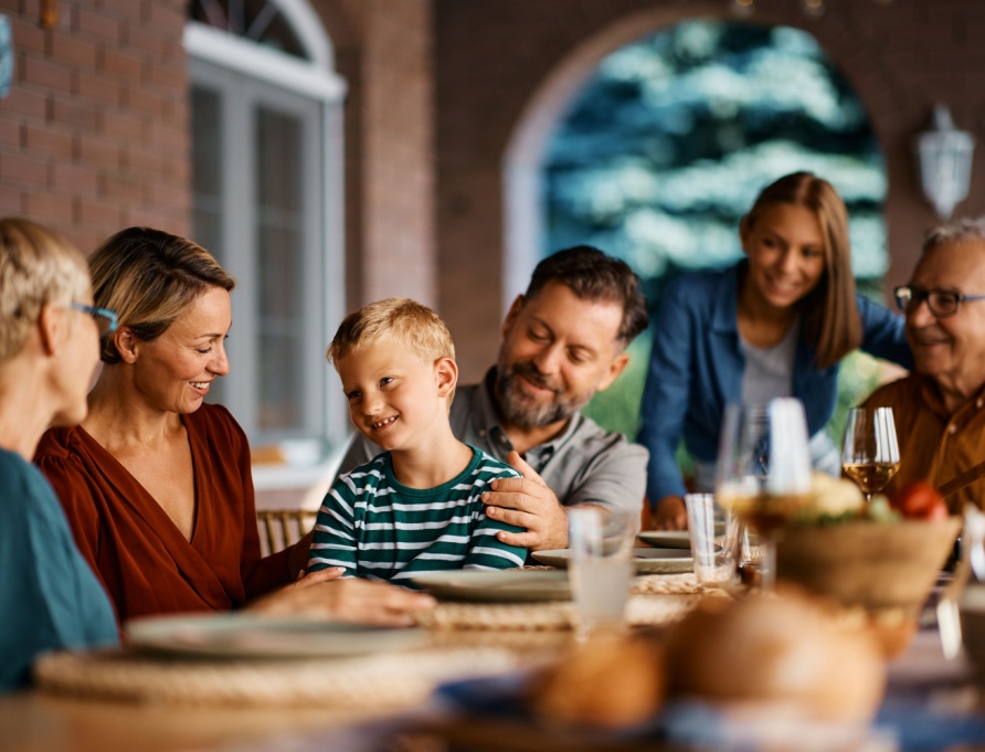 A multi-generational family eating dinner together.