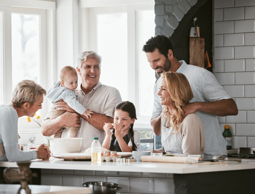 Three generations of family cooking in the kitchen