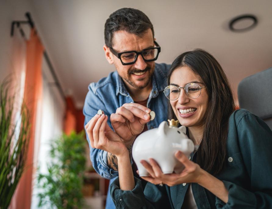A couple saving in a piggy bank.