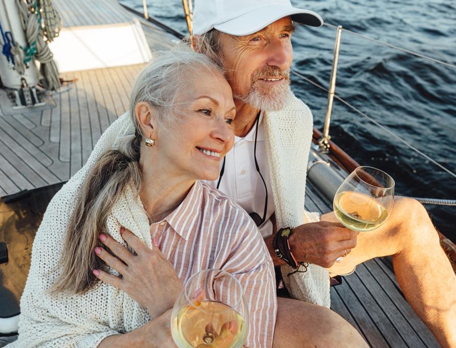 A couple sitting on a yacht deck.