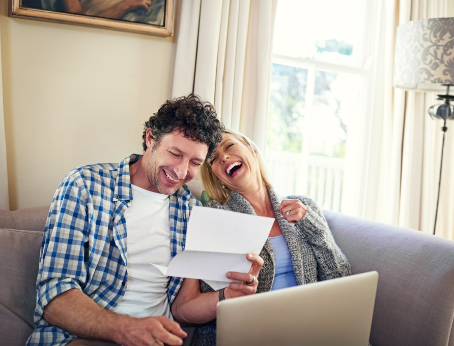 A happy couple reviewing paperwork.