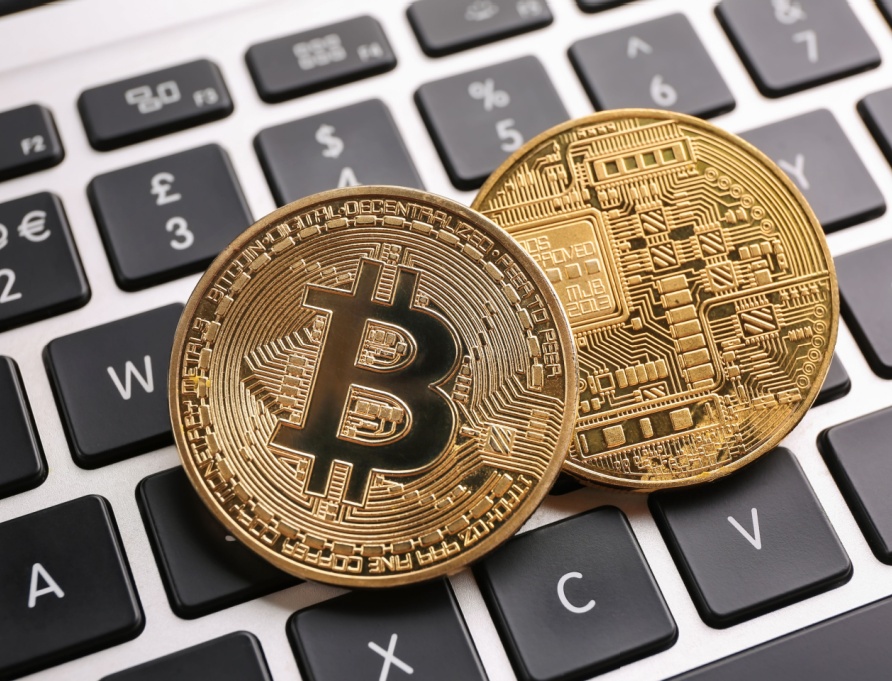 Depiction of physical bitcoins on a keyboard.